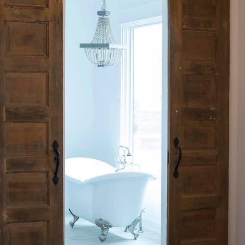 Antique Pocket doors opening to claw footed bathtub